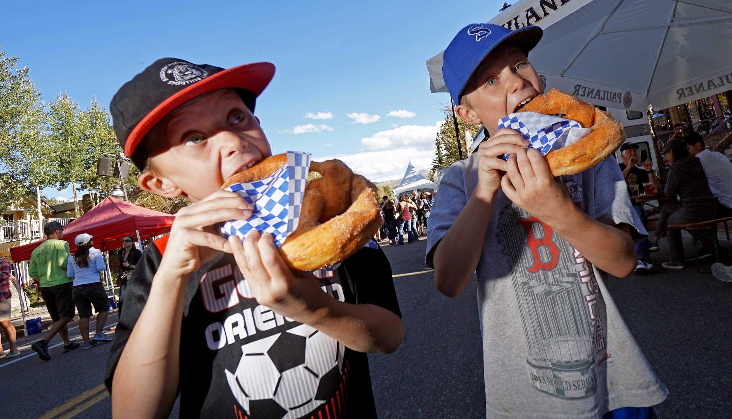 Kids at Oktoberfest eating pretzels