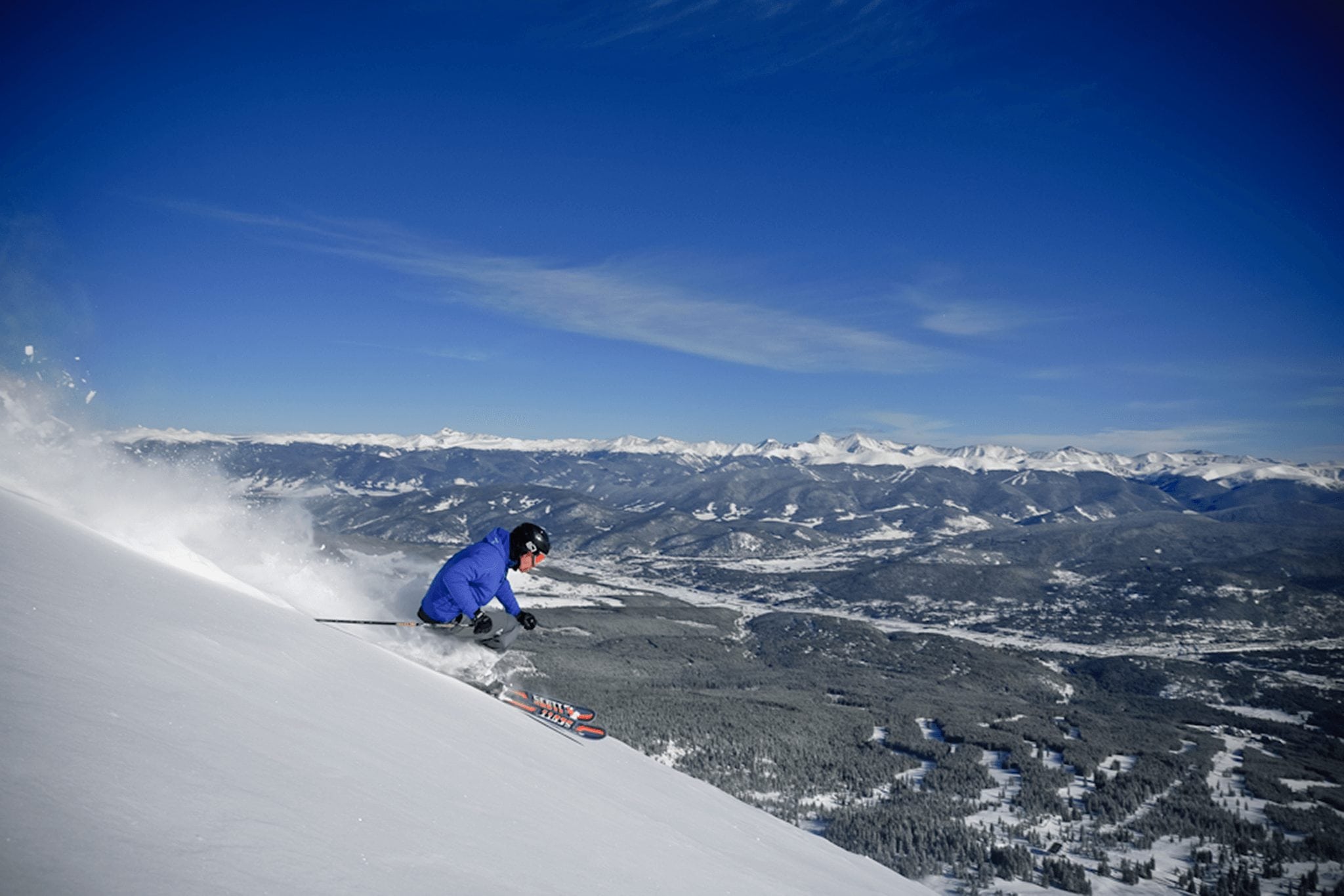 Skier Making turns on the Slopes while spring skiing at Breckenridge Ski Resort.