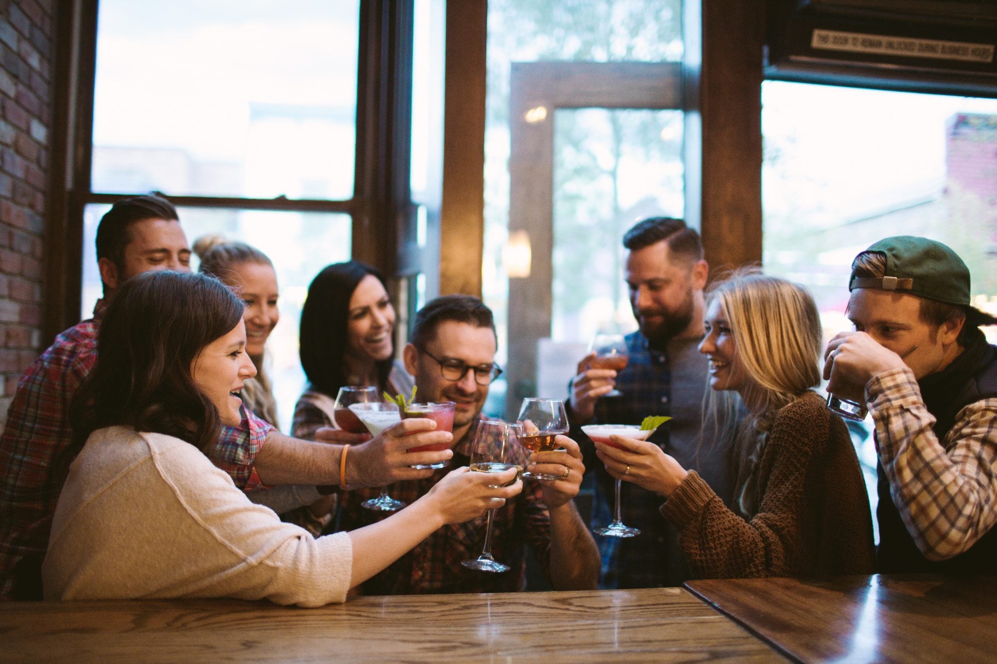 Group of friends sharing drinks at a Breckenridge bar during Breckenridge apres time.