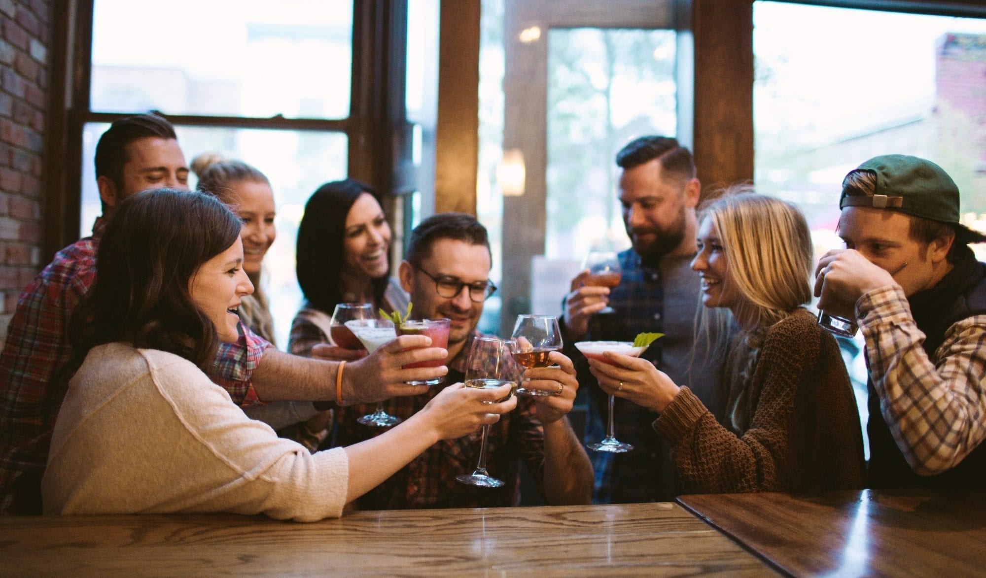 Group of friends sharing drinks at a Breckenridge bar.
