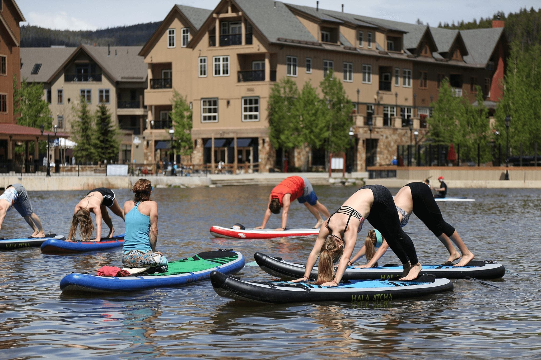 A group of people practicing yoga on paddle boards in Breckenridge.