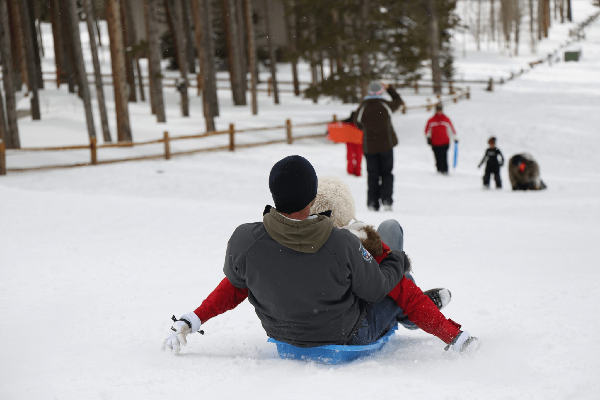 A family sleds down the hill in Breckenridge. Sledding is one of the most popular winter activities in Breckenridge.