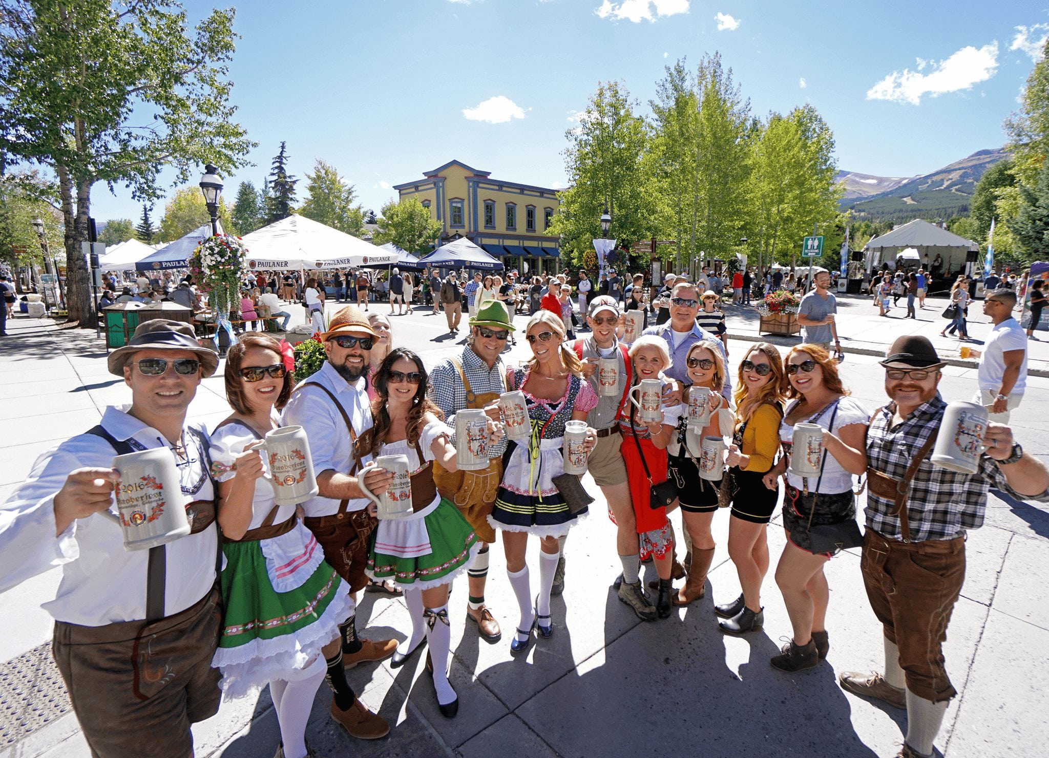 A group drinking from steins during Oktoberfest in Breckenridge