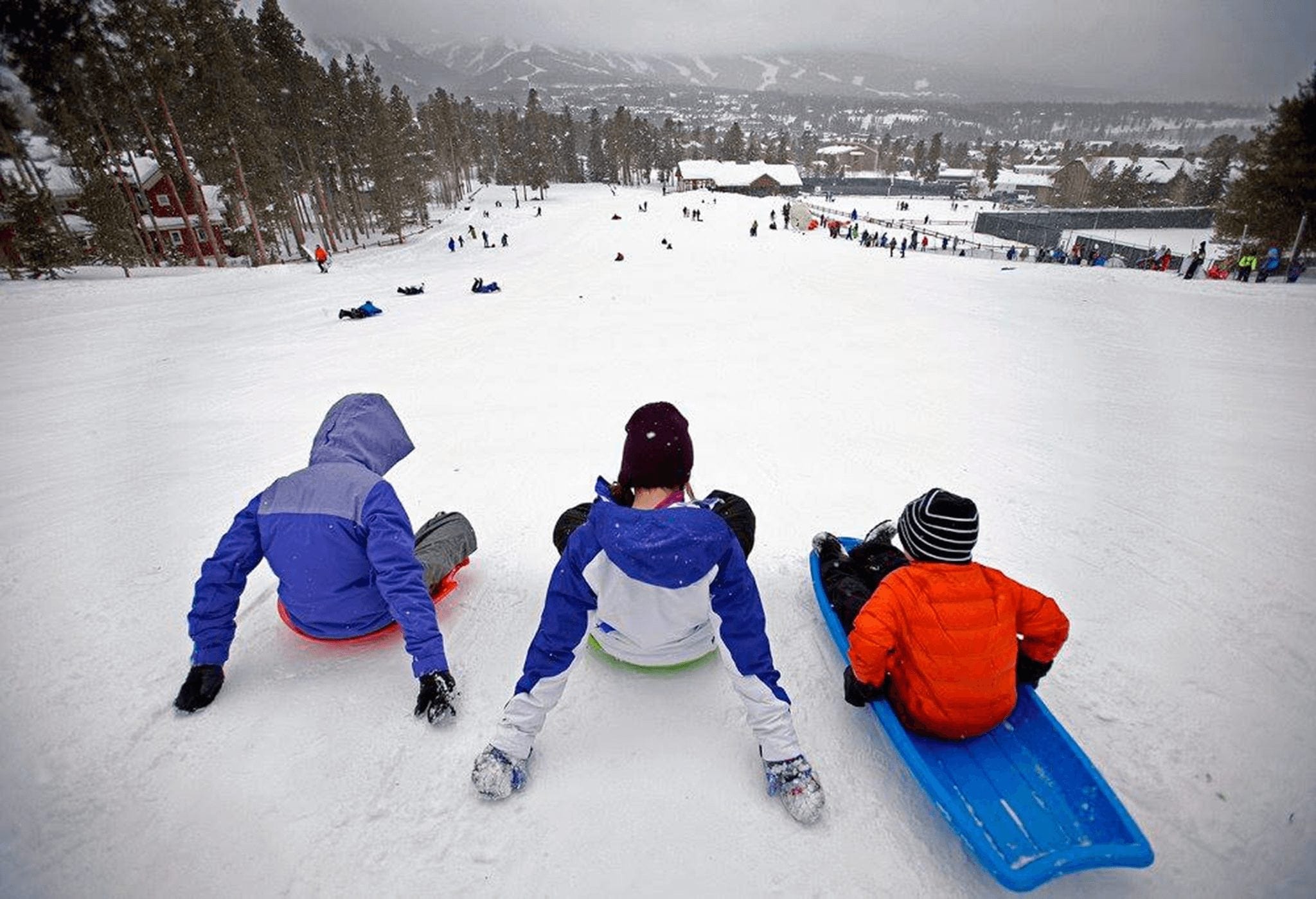 Mom and kid sledding in Breckenridge