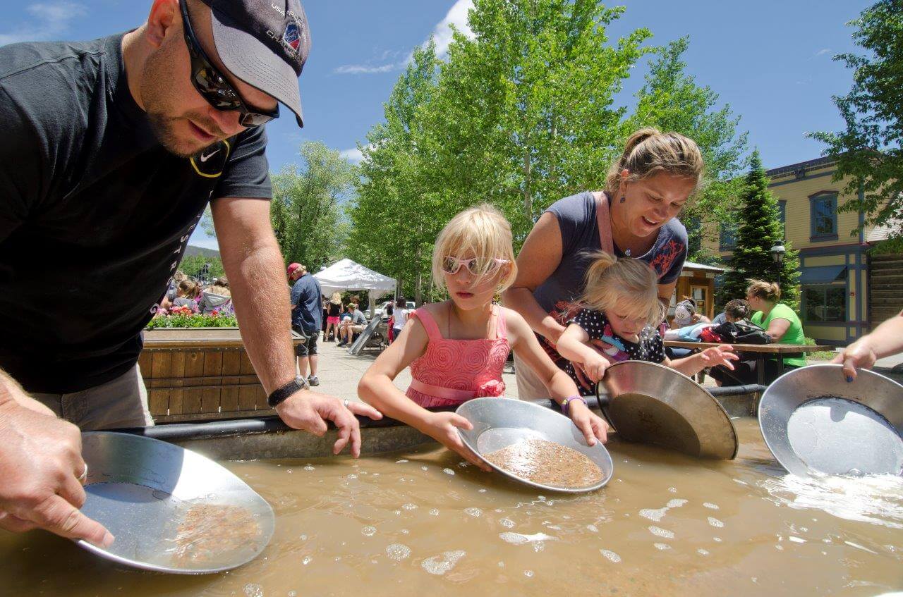 Family panning gold from sluice